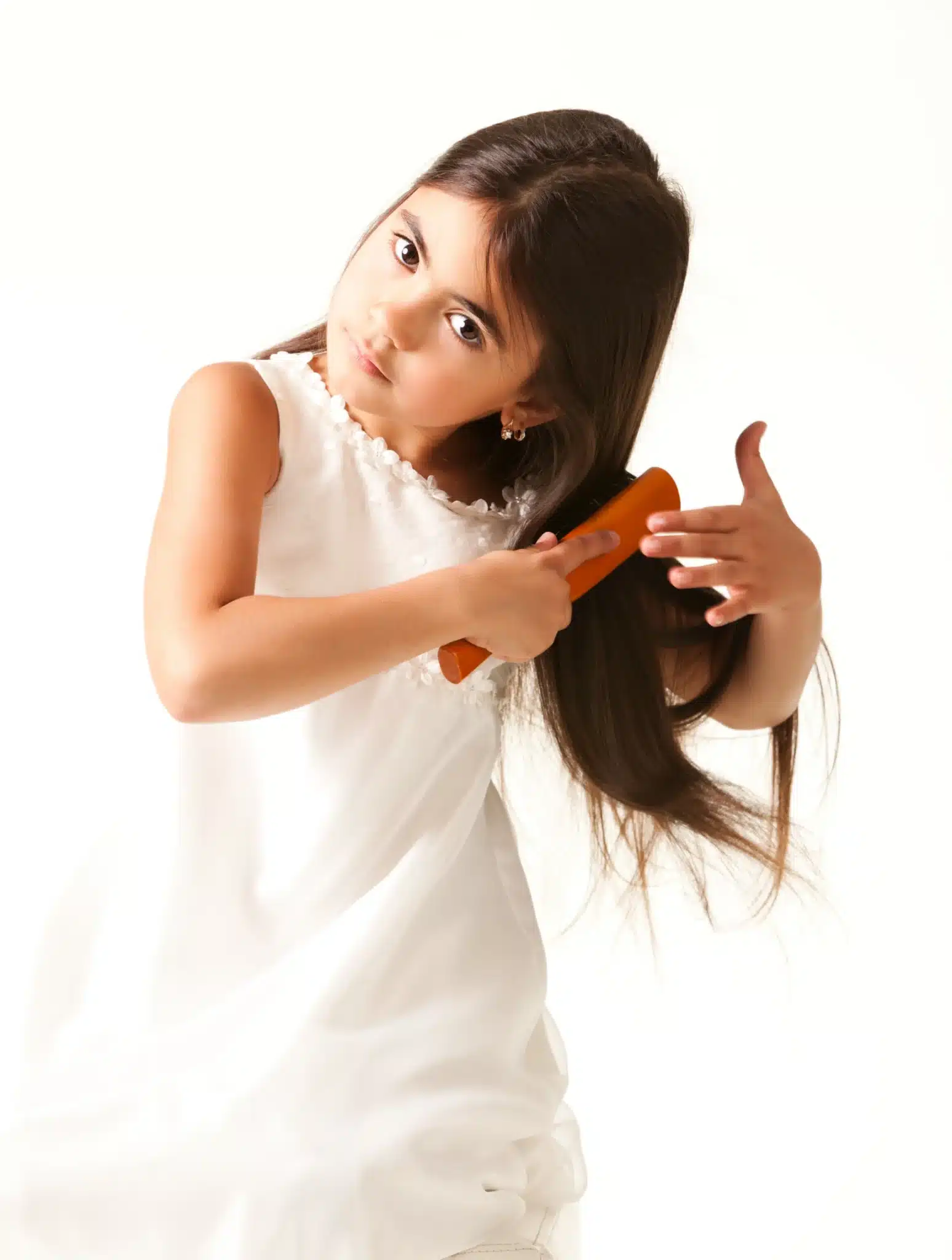 Plainview girl in white dress combing brown hair scaled